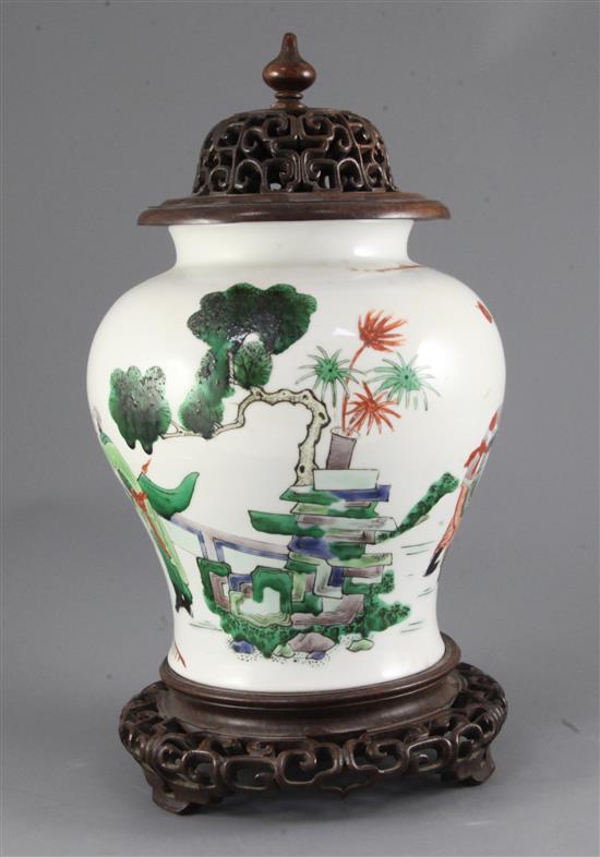 A Chinese famille verte baluster jar, wood cover and stand, 19th century, Kangxi mark, total height including cover and stand, 34cm
